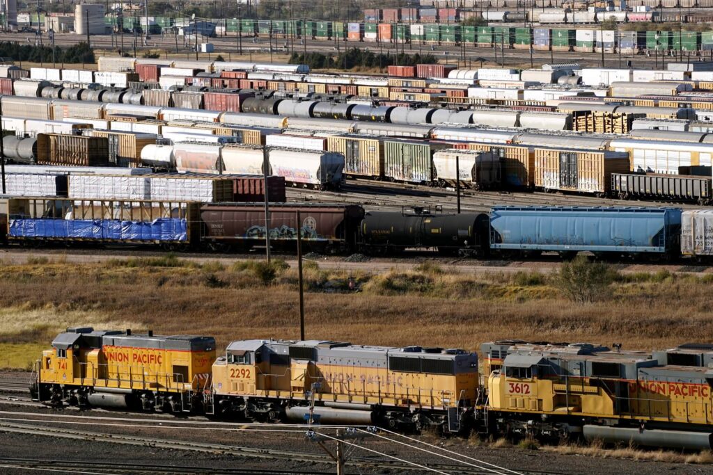 A railroad freight classification yard with numerous freight trains.