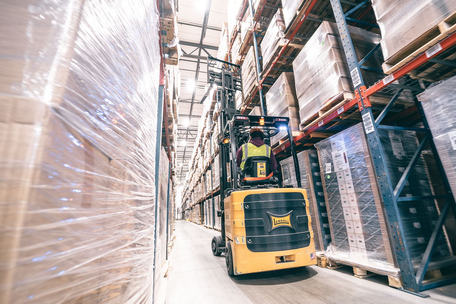 A forklift operator moving packages.