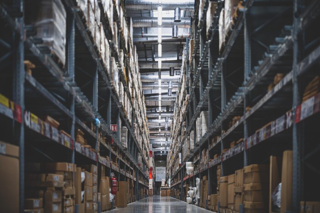 Warehouse aisle with high stacks of shelves with boxes