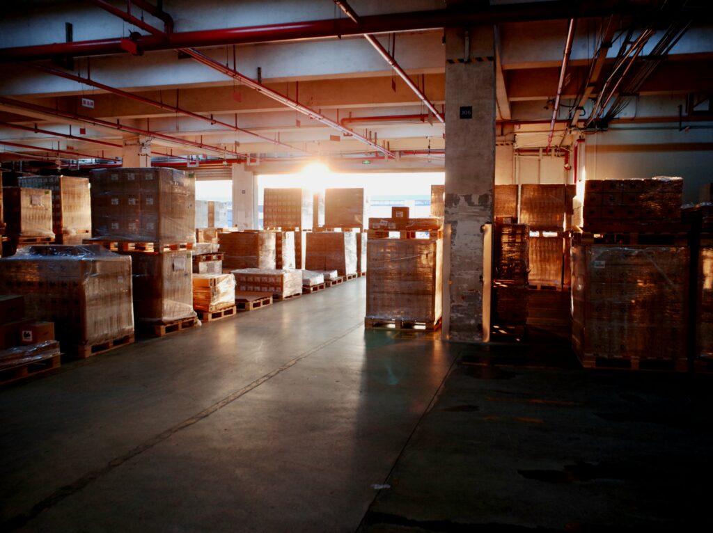 Interior of a warehouse with the sun shining from the door