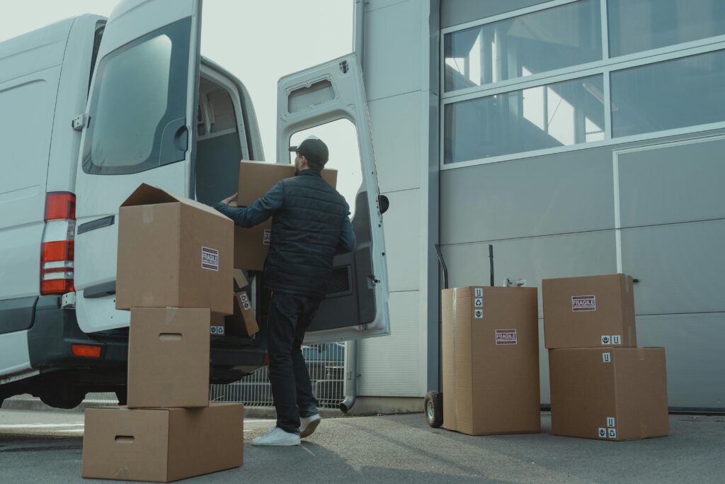 a man loading boxes into a delivery van