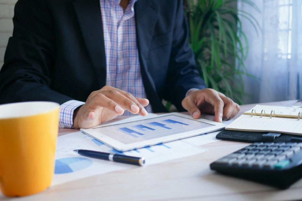 A person holding a tablet with a chart