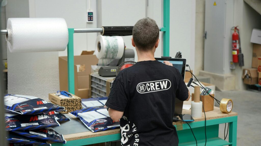 A man standing in front of packaging materials.