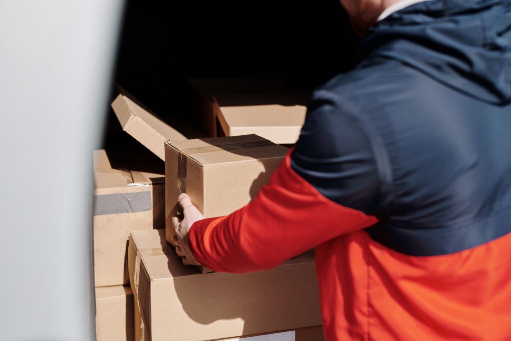 A person handling cardboard boxes.