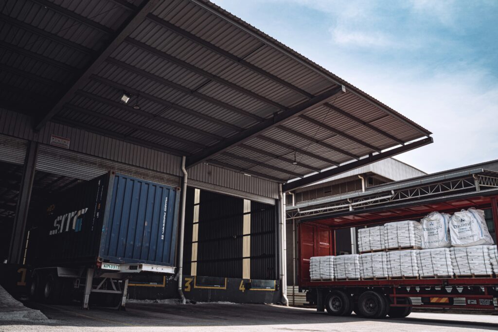 A truck loaded with white bags.