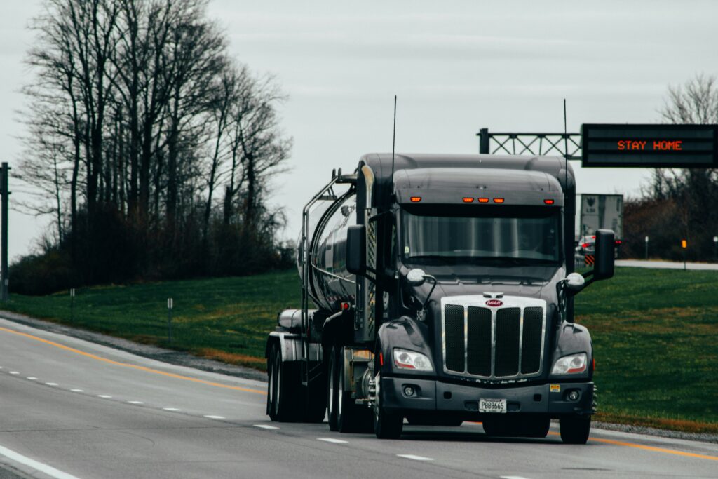 A black truck on an open road.